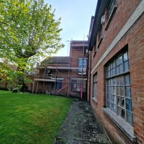 Brick building with large windows off a courtyard